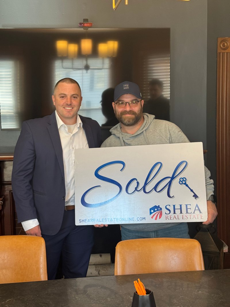 Happy family celebrating successful home sale with Jared Mason