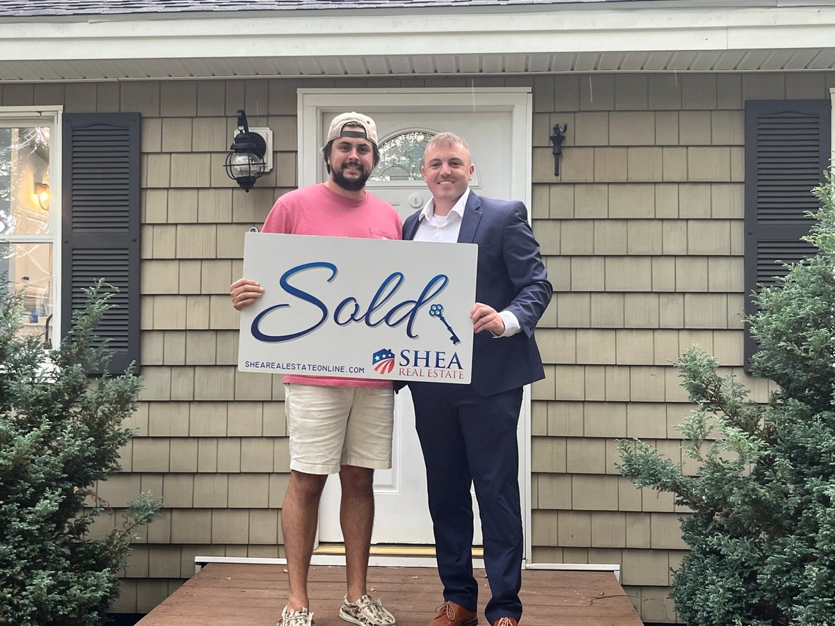 Jared Mason with happy home buyer holding SOLD sign